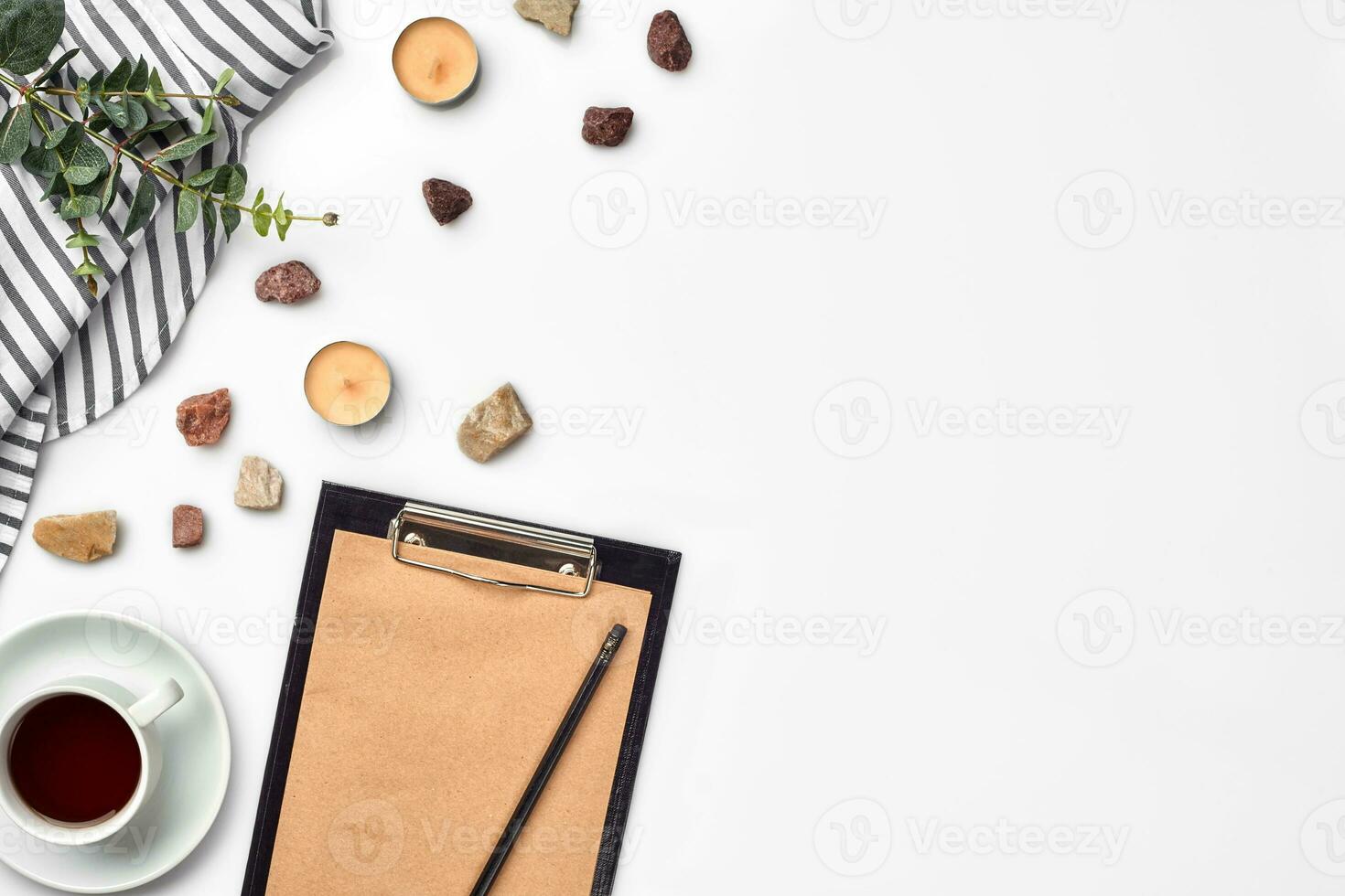 Blank opened notebook with cup of coffee on white table. Top view. Writing concept photo