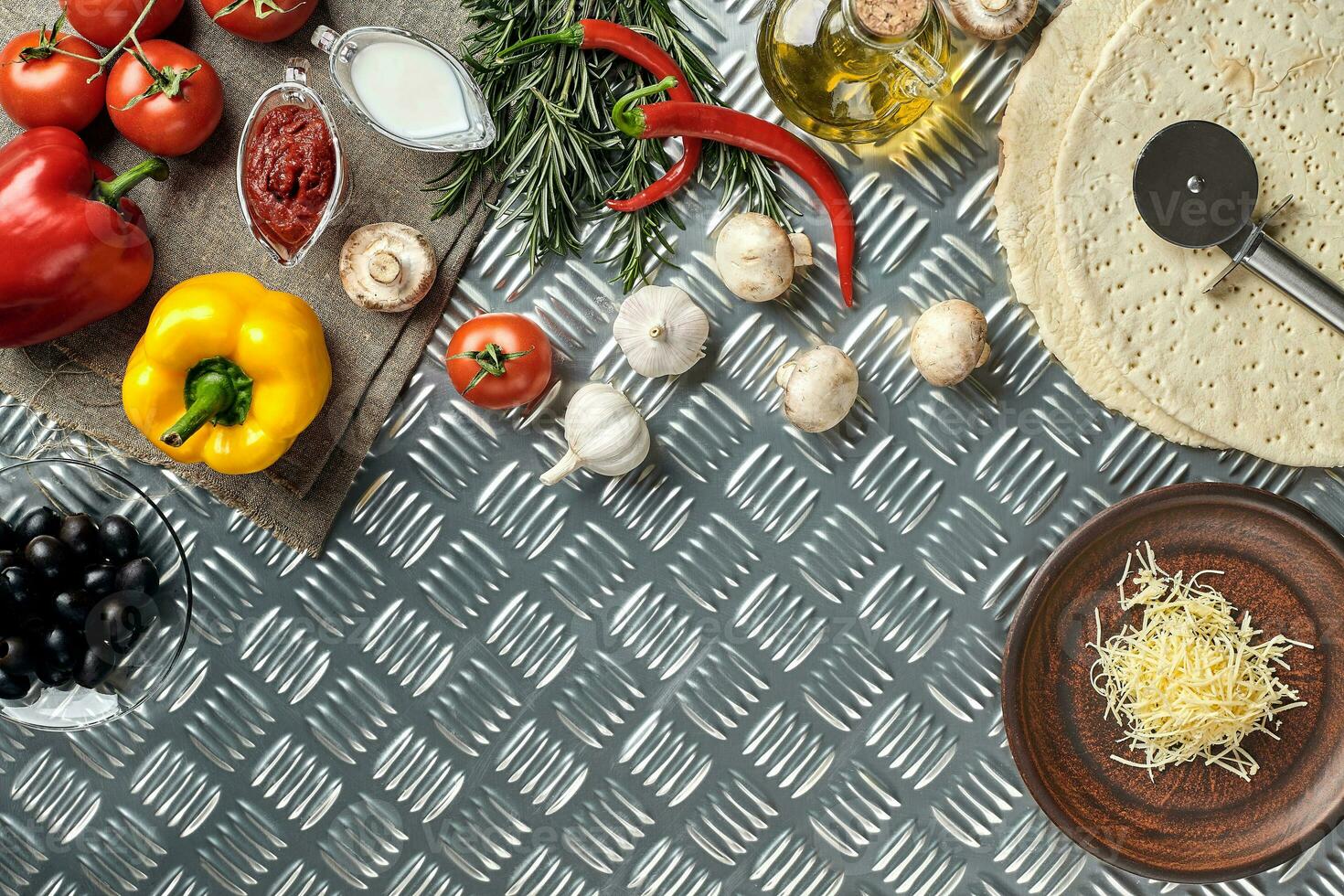 Cheese, different vegetables on metal table. Ingredients for traditional italian pizza. photo