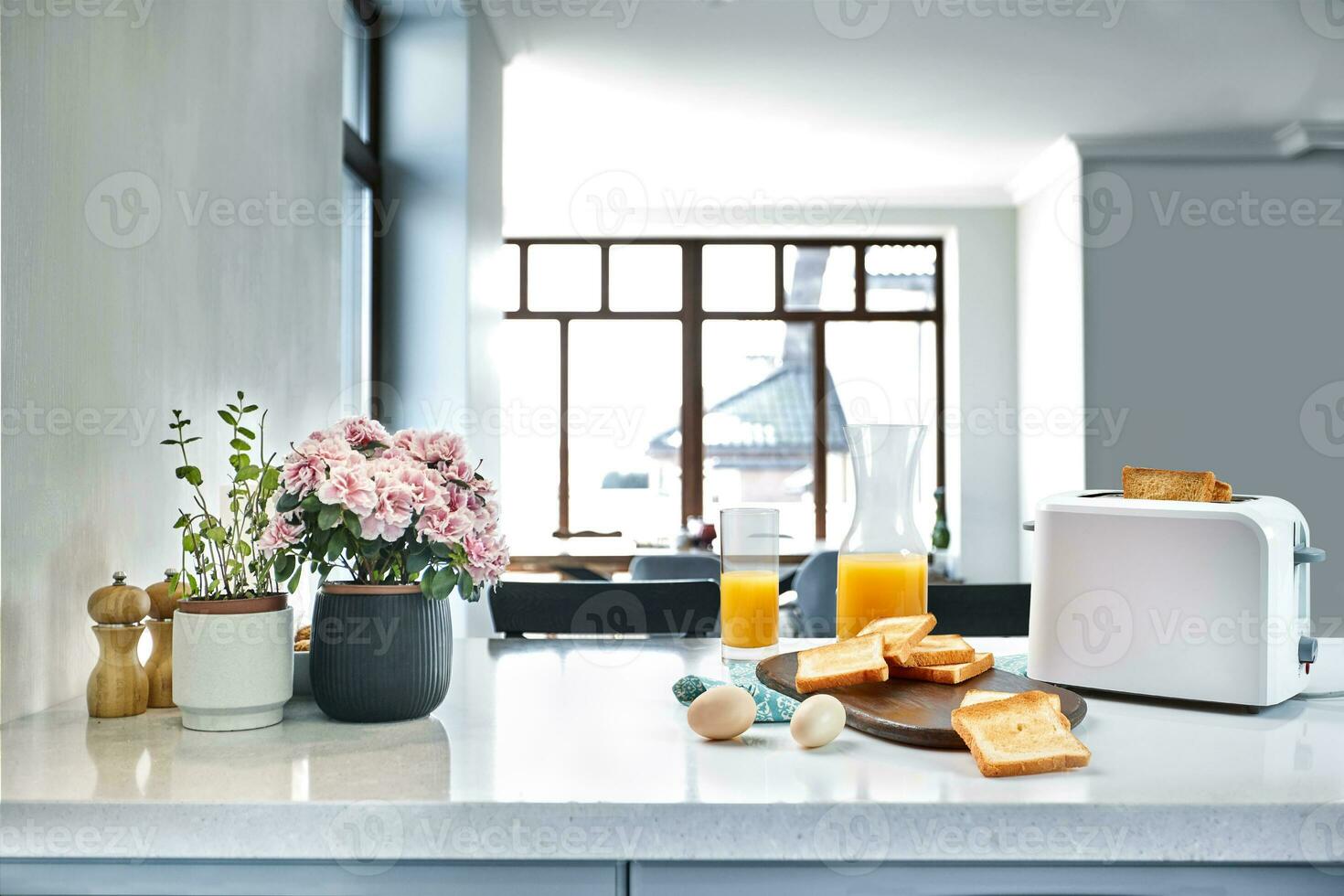 Portion of toasts on a wooden board with orange juice. Breakfast is served on a table with light blue napkin. photo