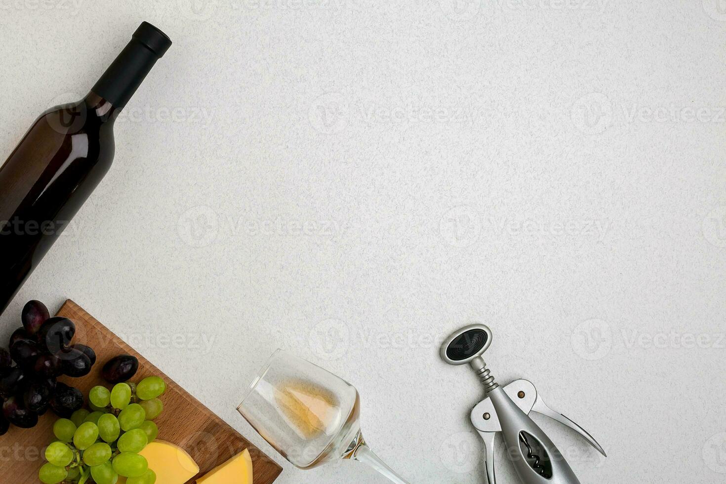 Wine, glasses and corkscrew over white background. Top view photo