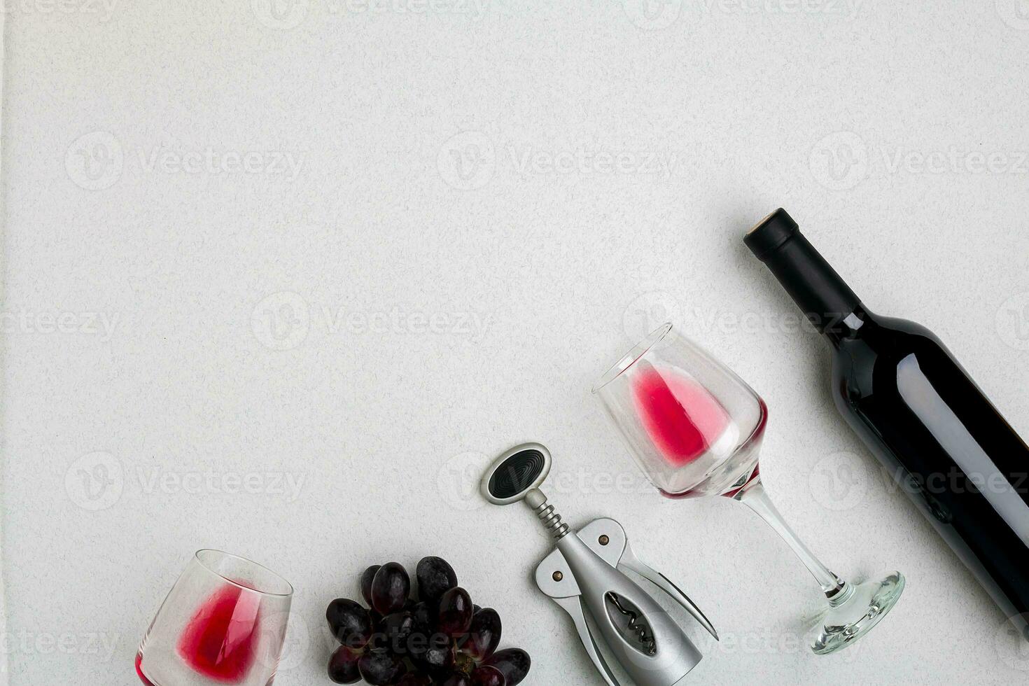 Wine, glasses and corkscrew over white background. Top view photo