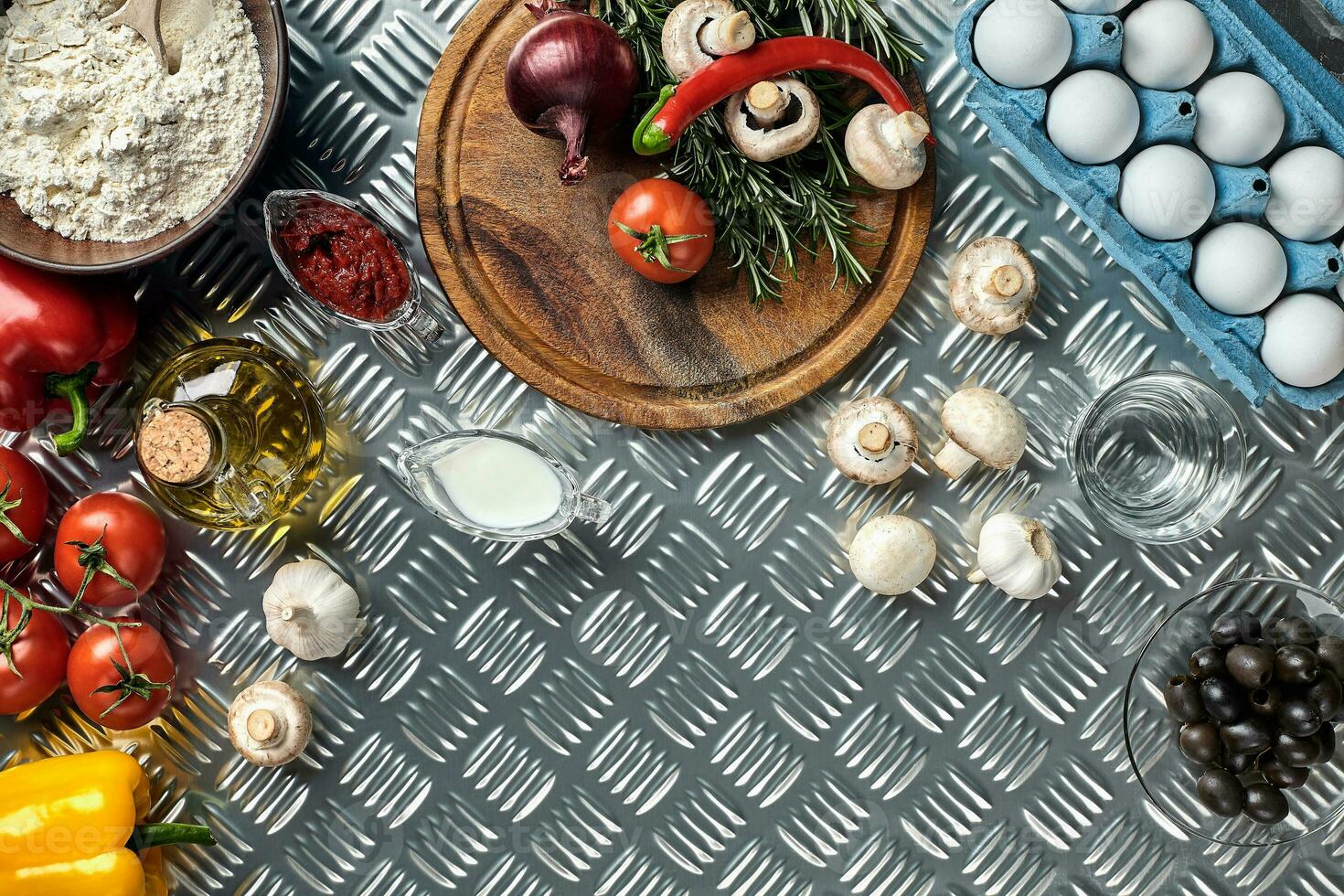 Cooking Pizza. Pizza ingredients on the iron table with copy space, top view. photo