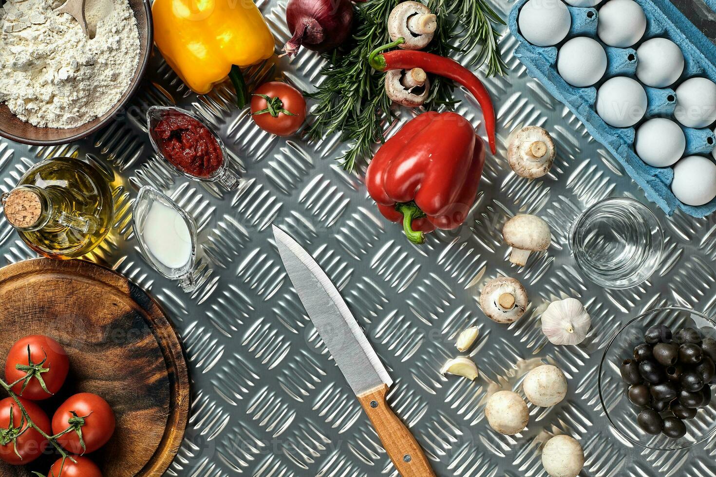 Cooking Pizza. Pizza ingredients on the iron table with copy space, top view. photo