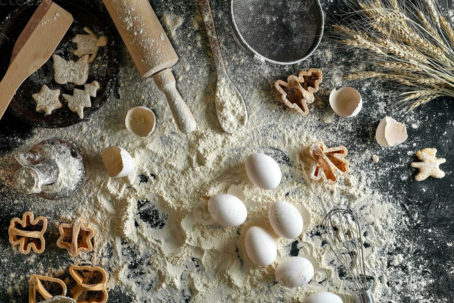 Cooking dough for cookies, butter, eggs, cooking equipment, flour on a black table. Top view with copy space, mockup for menu, recipe or culinary classes. Baking background. photo