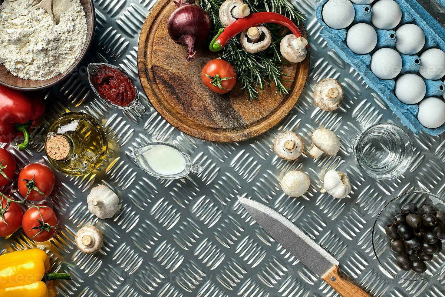 Cooking Pizza. Pizza ingredients on the iron table with copy space, top view. photo