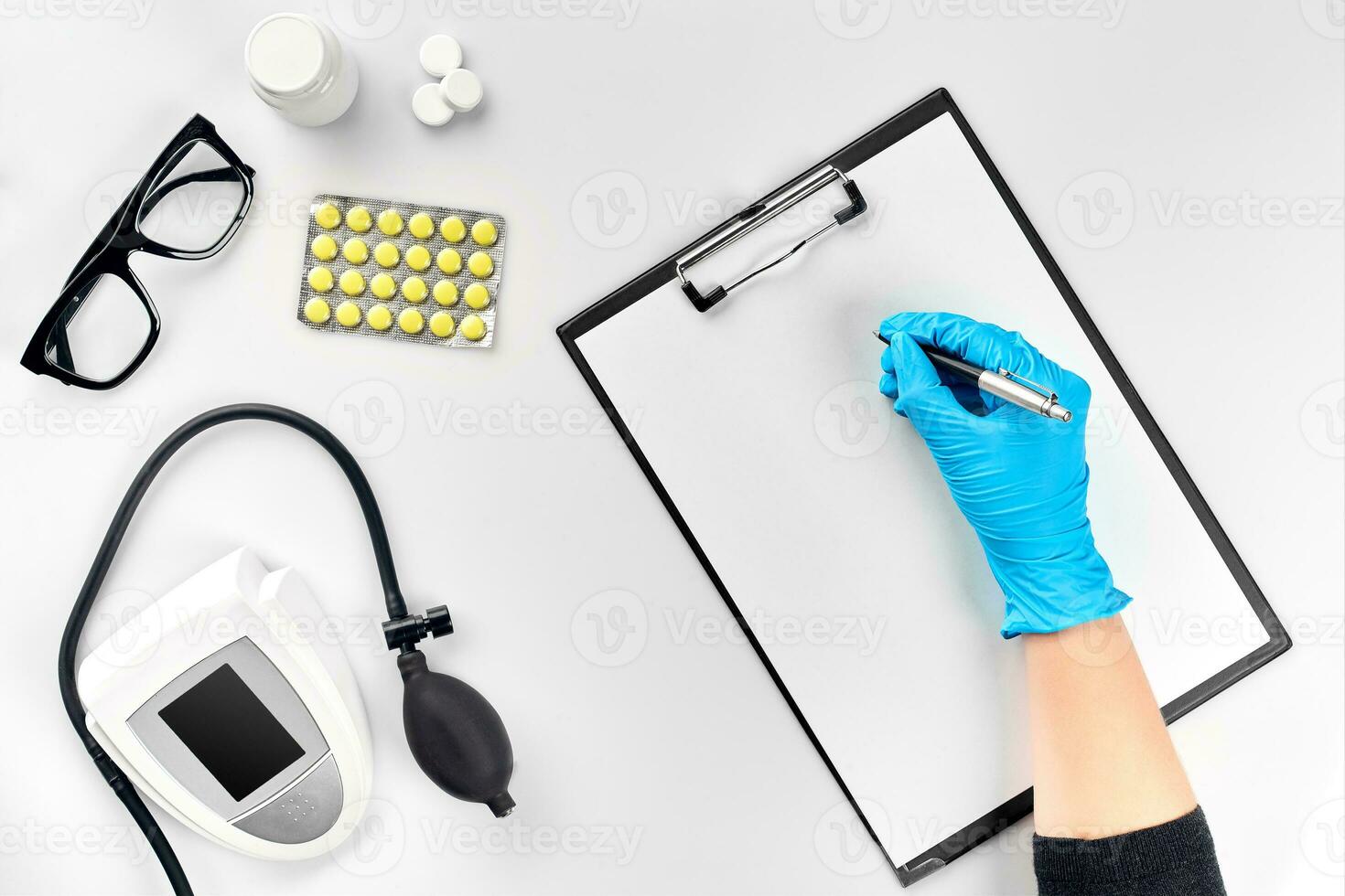 Doctor s table, tools, medical instruments, therapist tonometer, blood pressure, work in hospital on white background flat lay photo