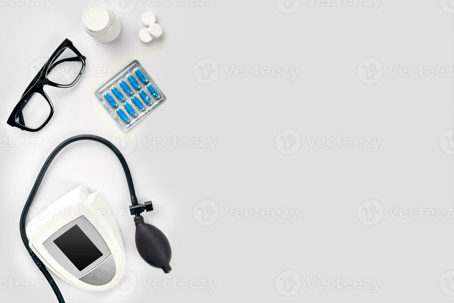 Electronic medical tonometer for measuring blood pressure on a white table photo