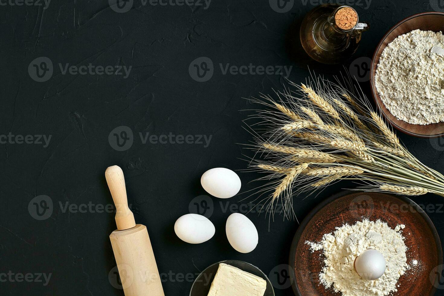 Pasta cooking ingredients on black kitchen table. Top view with space for your text photo