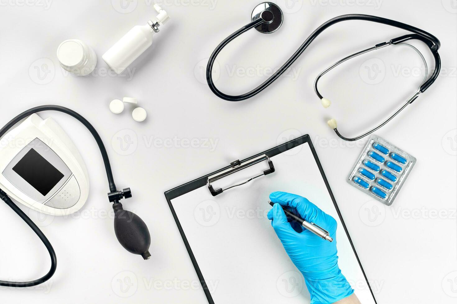 Doctor s table, tools, medical instruments, therapist tonometer, blood pressure, work in hospital on white background flat lay photo