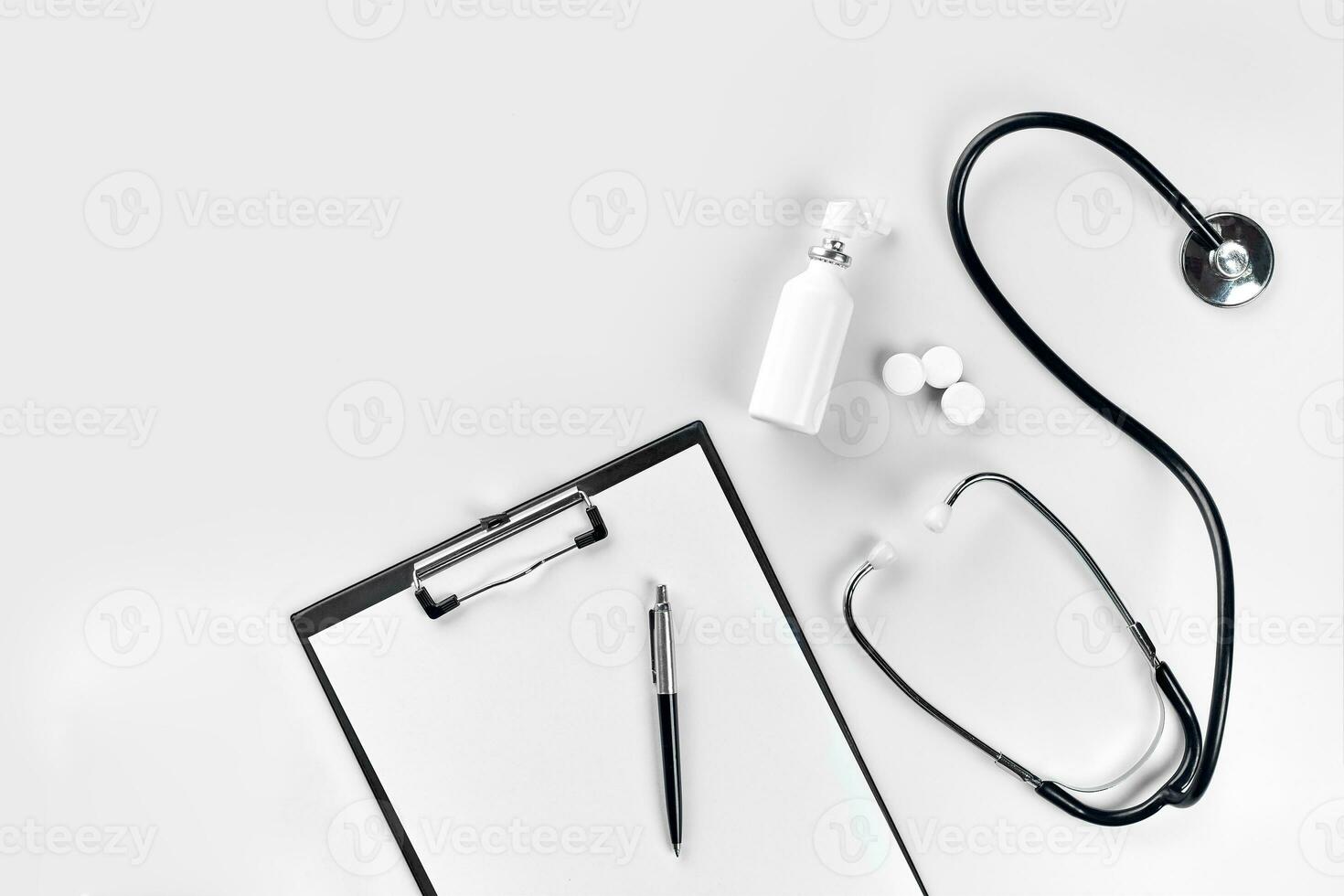 Stethoscope, pills, tablet on white background. Medicine concept photo