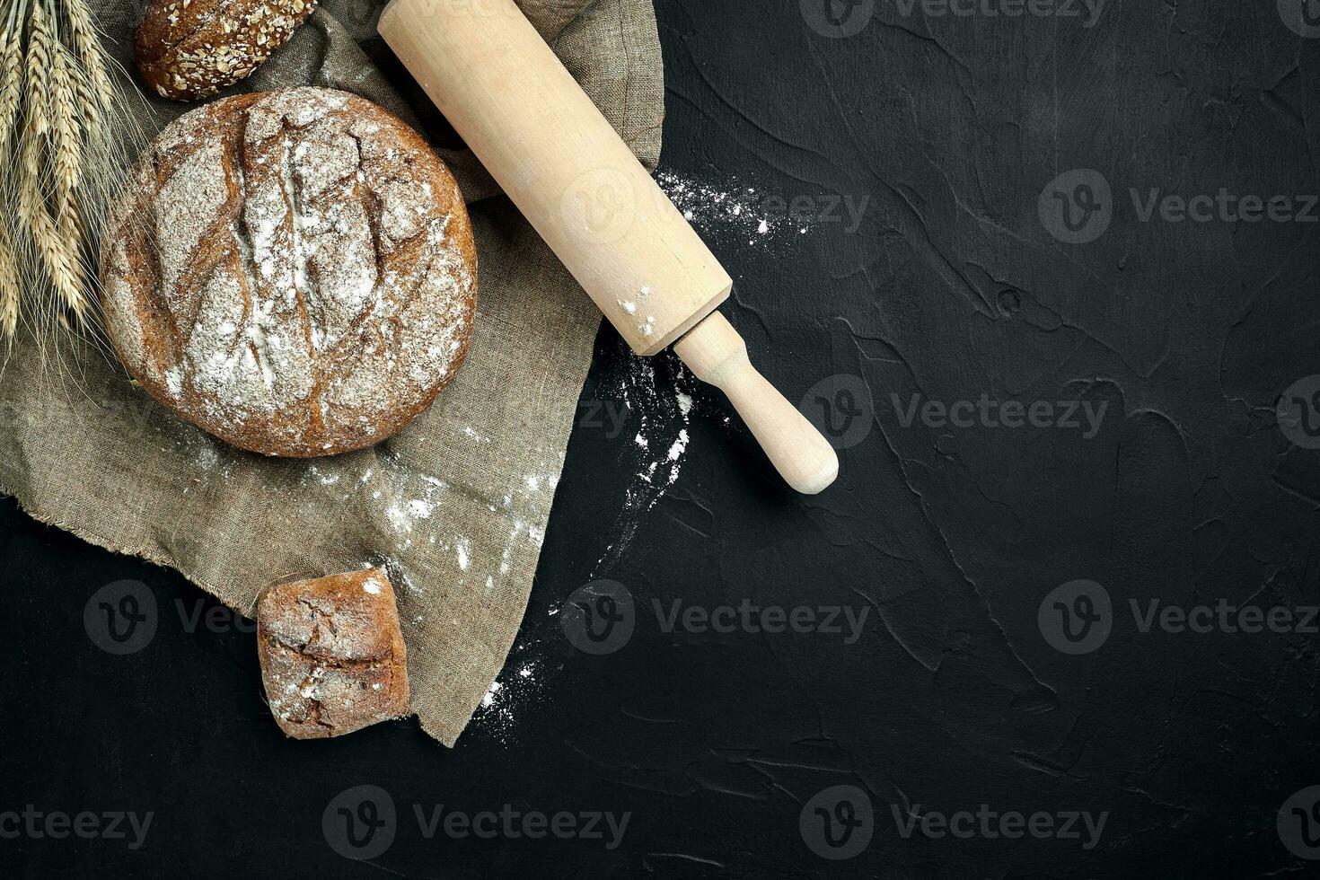 Freshly baked bread on dark kitchen table, top view photo