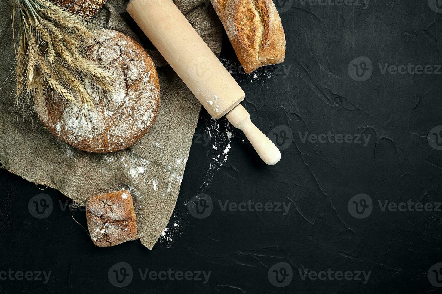 Freshly baked bread on dark kitchen table, top view photo