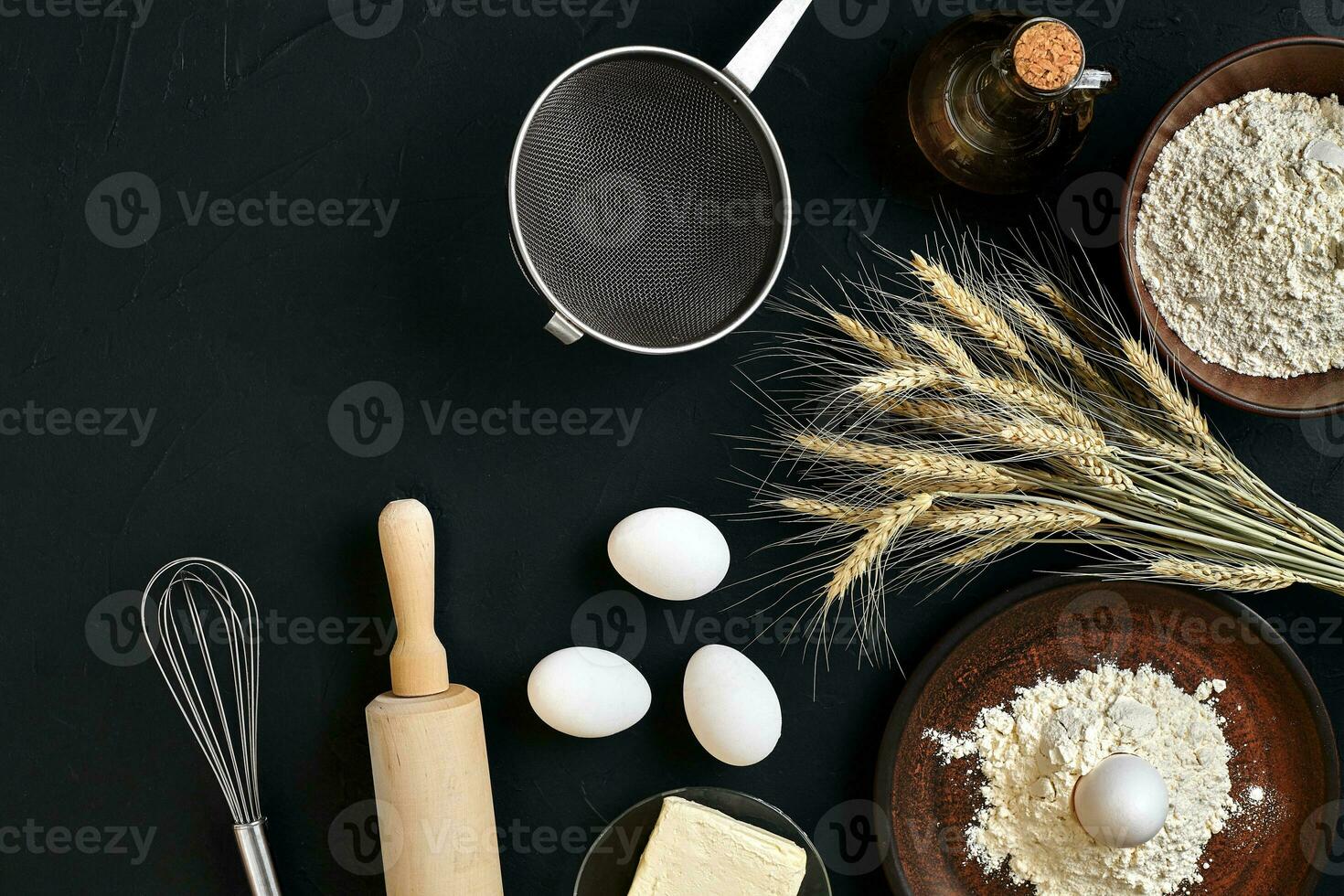 Pasta cooking ingredients on black kitchen table. Top view with space for your text photo