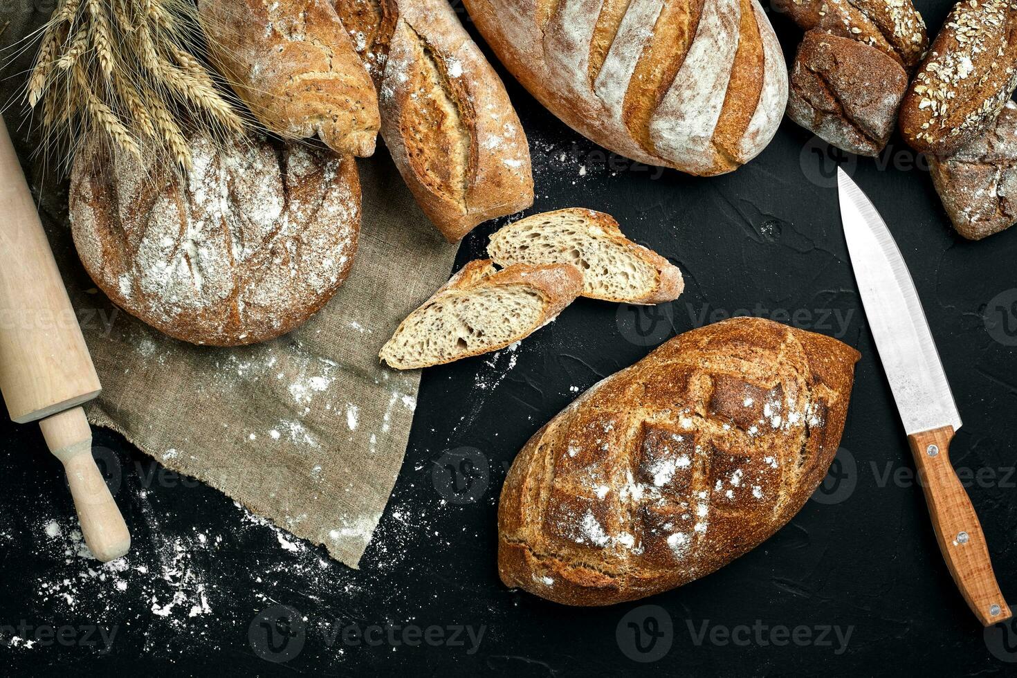 Mixed breads on black table. Top view with copy space. photo