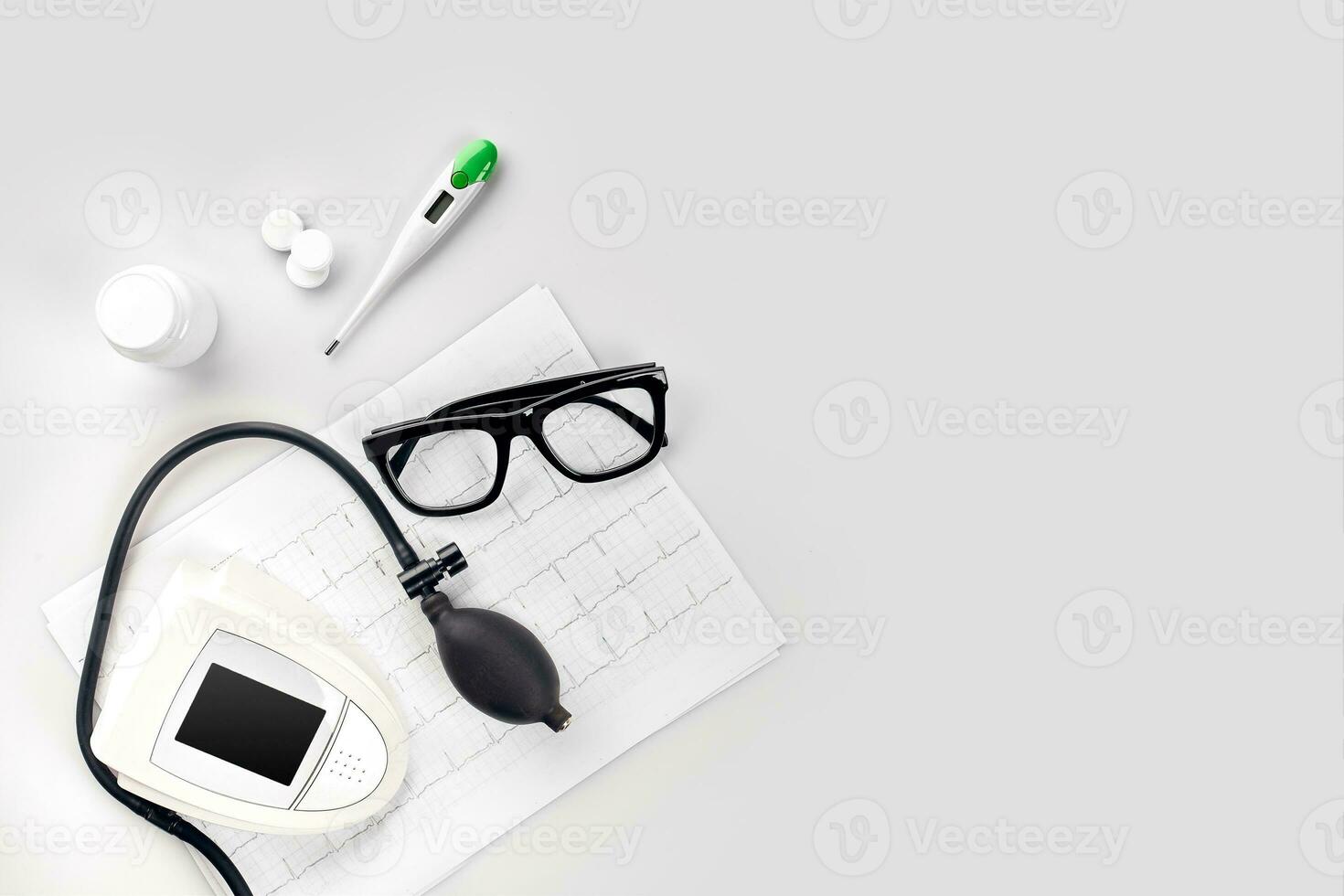 Electronic medical tonometer for measuring blood pressure on a white table photo
