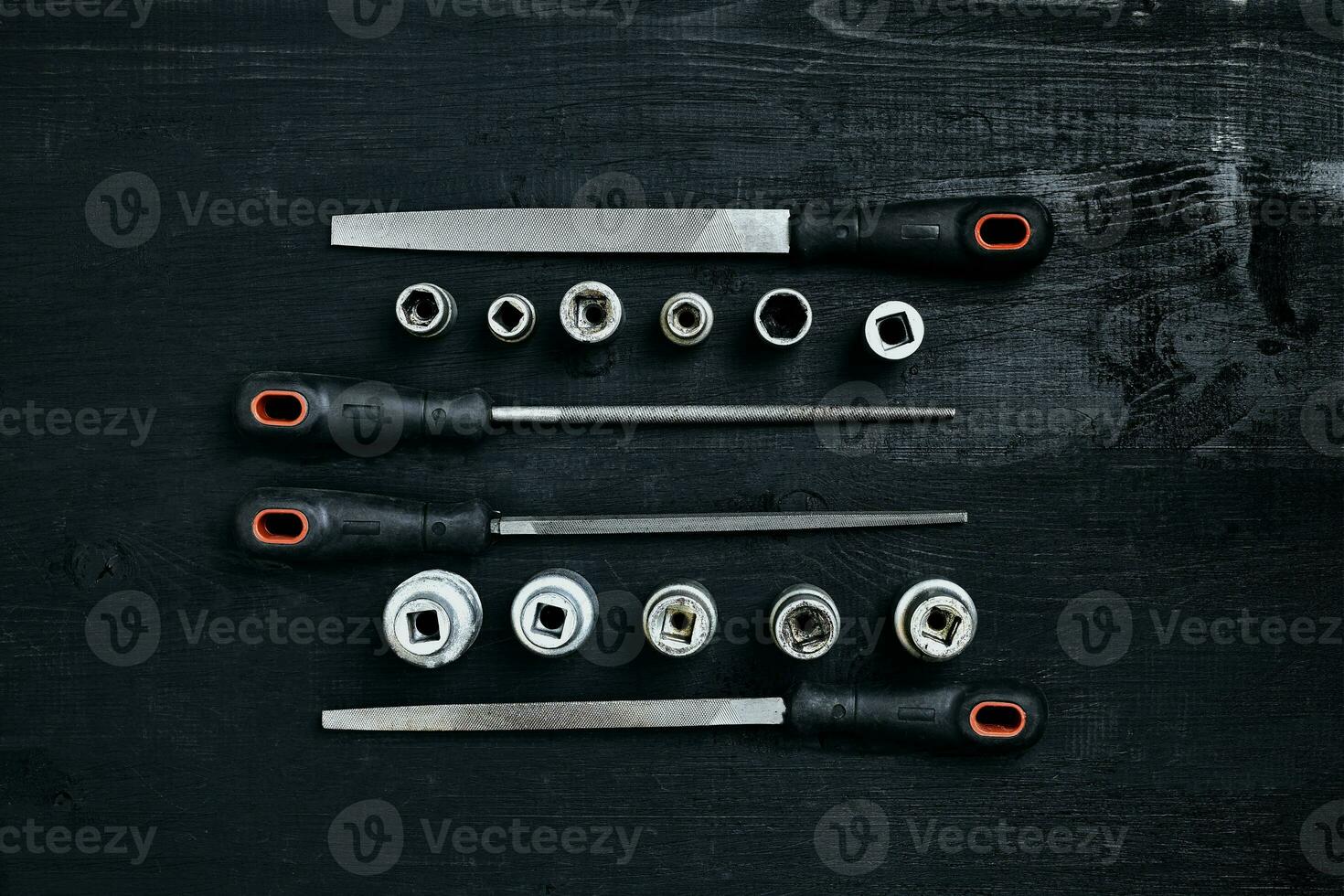 Set of tools chisel, wrenches on black wooden background photo