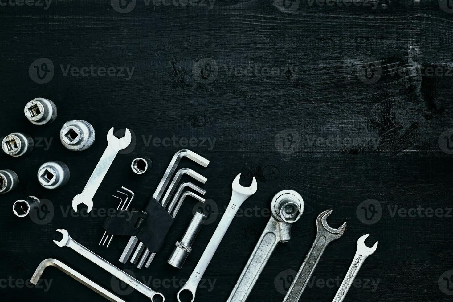 Tools for work or repair auto on black wooden background. Top view photo