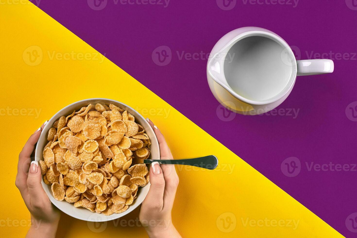 Food, healthy eating, people and diet concept - close up of woman eating muesli with milk for breakfast over purple and yellow background photo