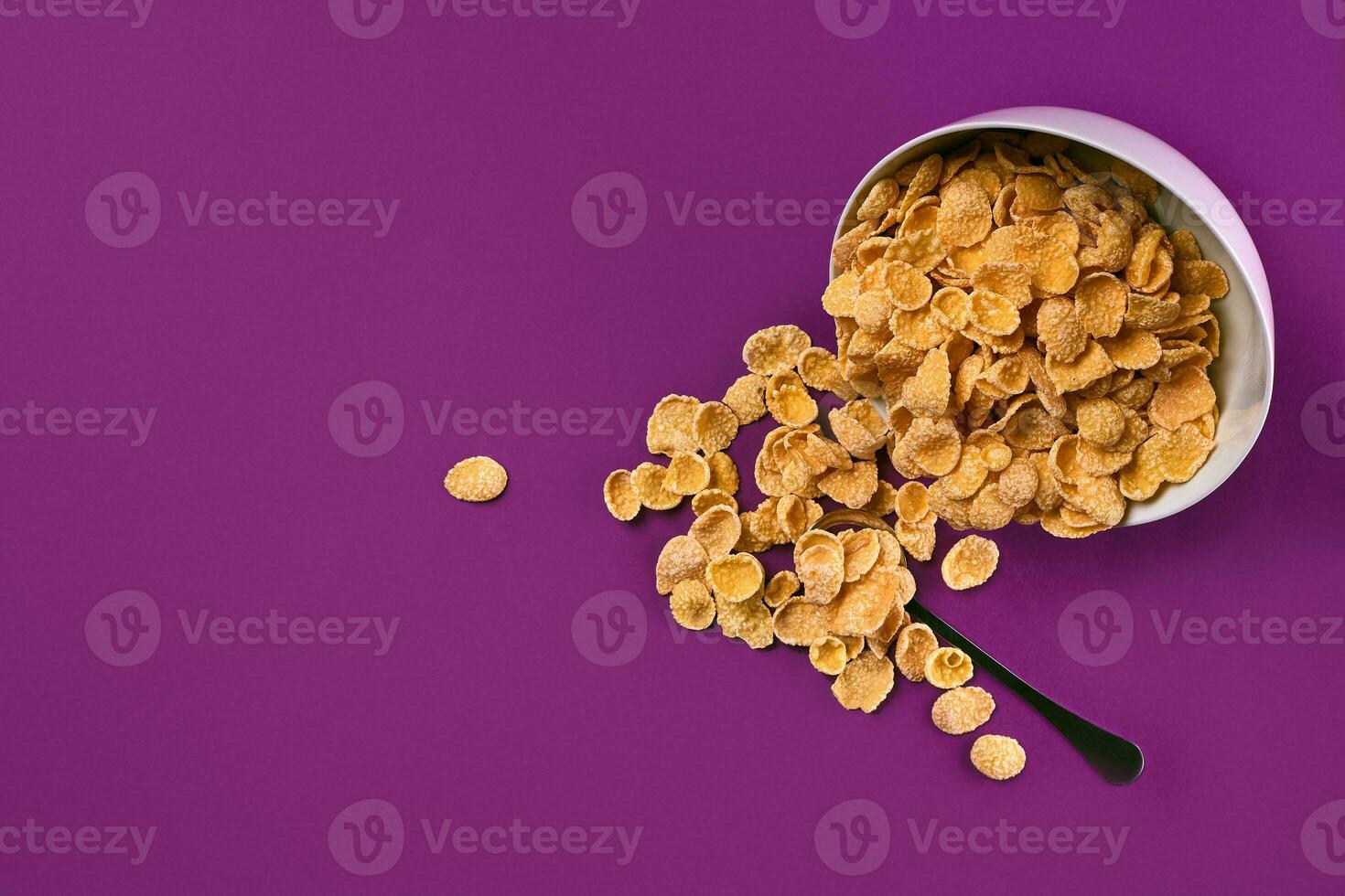 Bowl with cornflakes on the colorful background photo