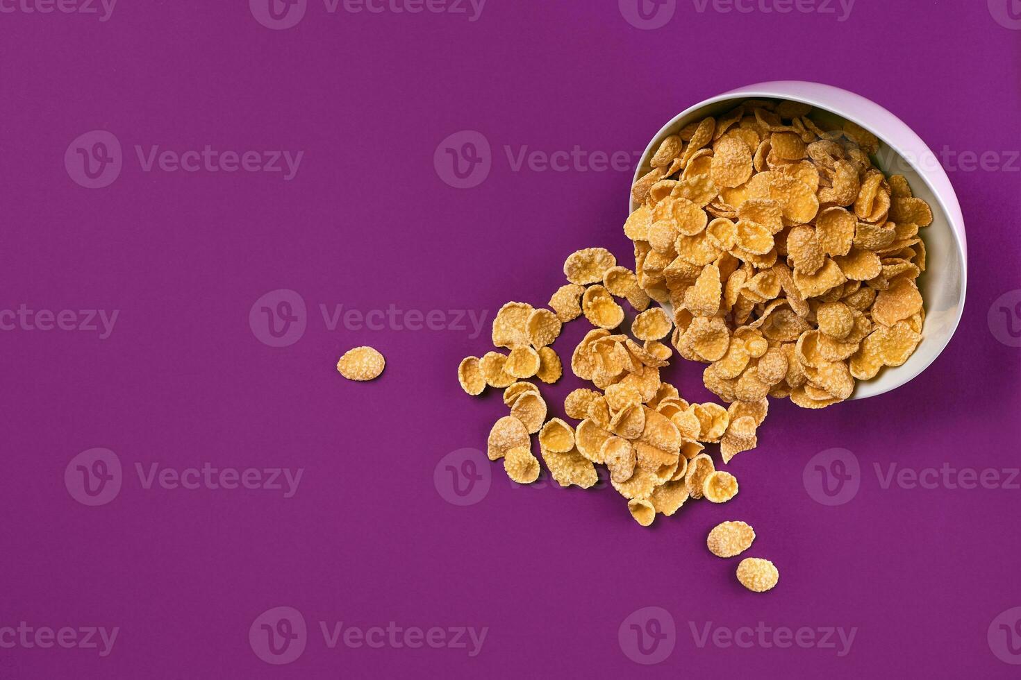 Bowl with cornflakes on the colorful background photo