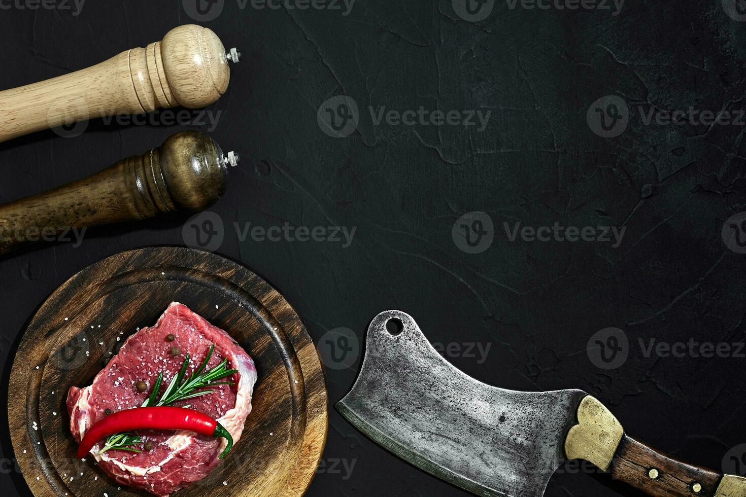 Raw beef steak dry aging on wooden cutting board. Copy space photo