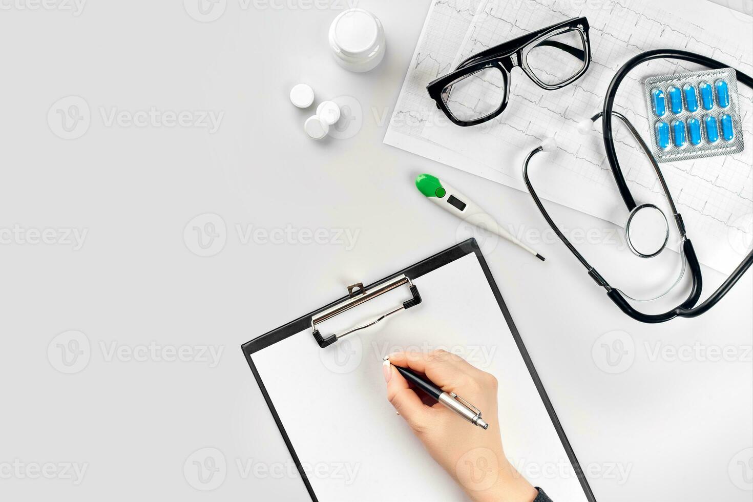 Doctor's work with stethoscope and copybook on hospital desk background. Top view photo