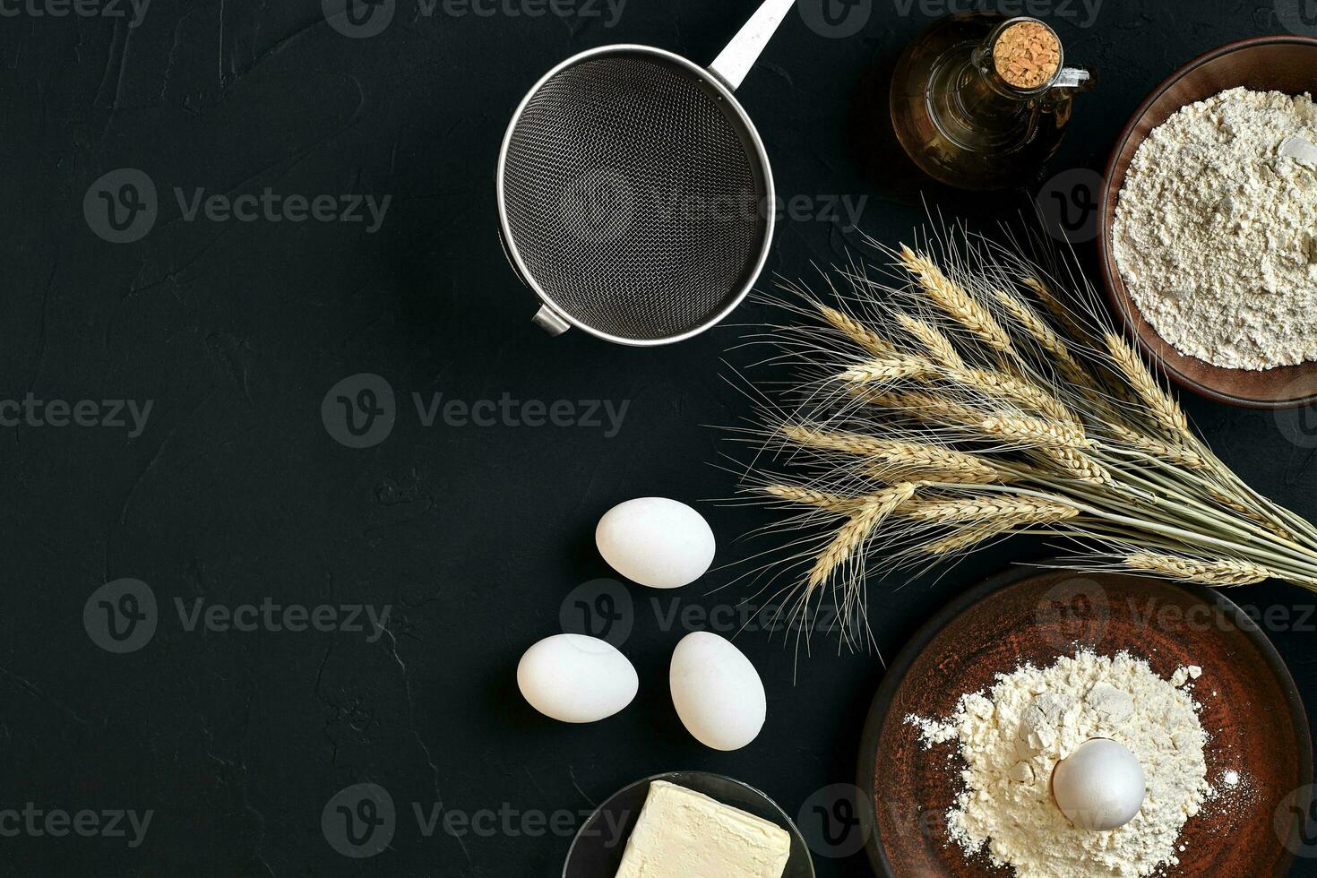 Pasta cooking ingredients on black kitchen table. Top view with space for your text photo