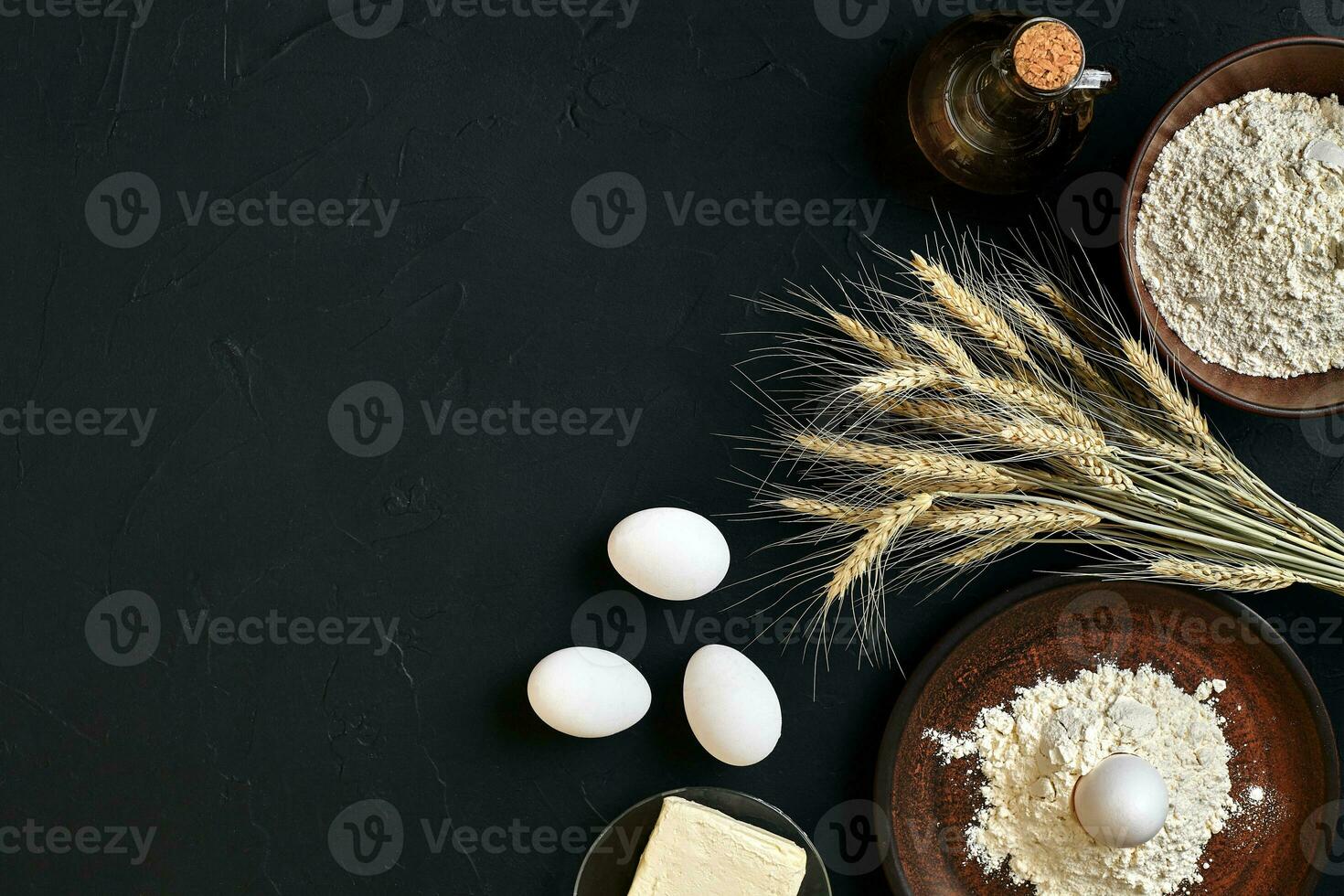 Pasta cooking ingredients on black kitchen table. Top view with space for your text photo