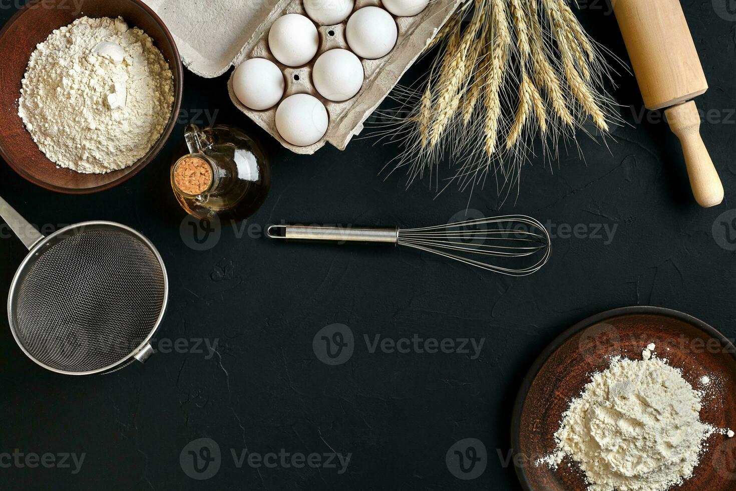 Pasta cooking ingredients on black kitchen table. Top view with space for your text photo