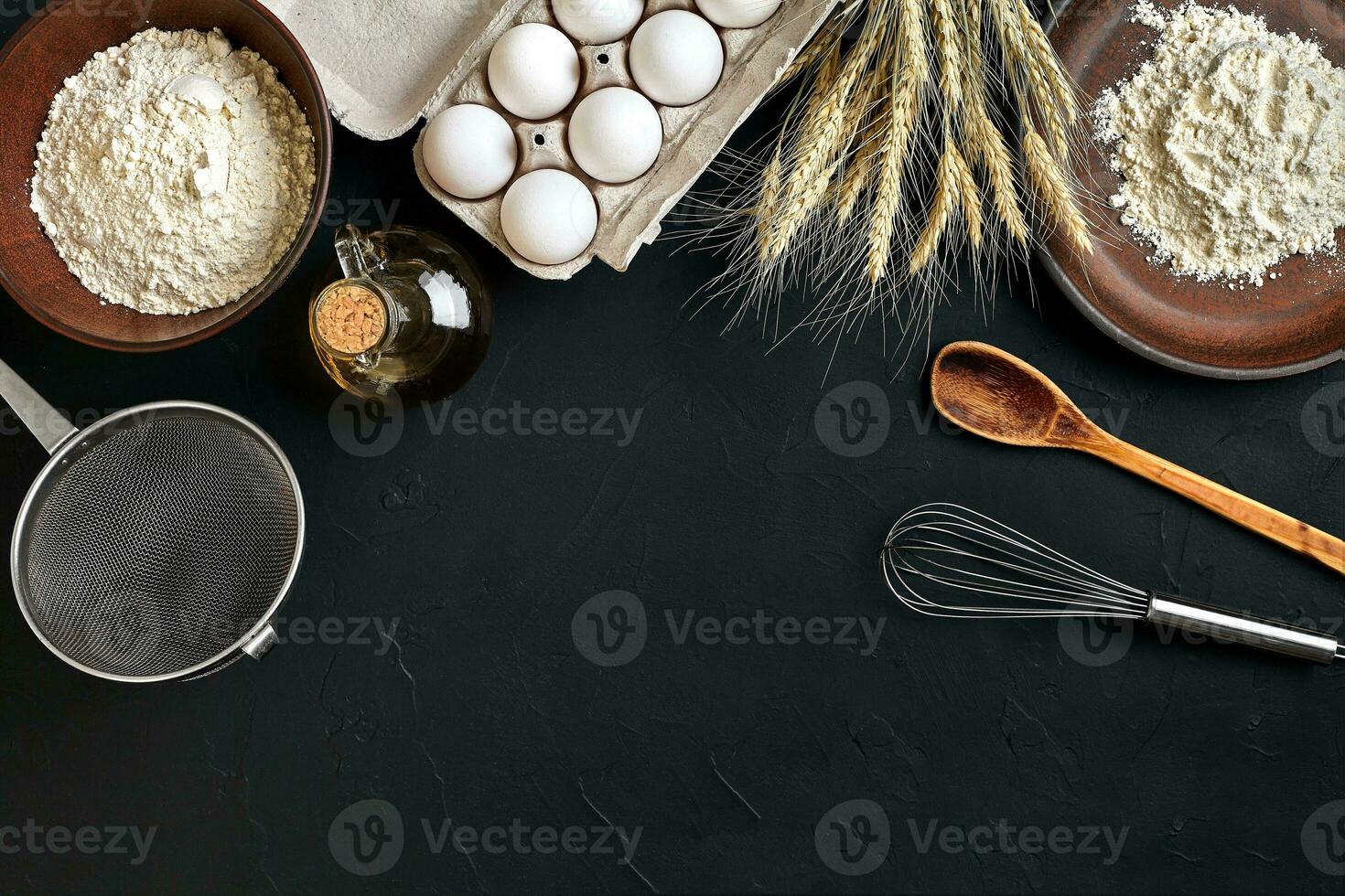 Pasta cooking ingredients on black kitchen table. Top view with space for your text photo