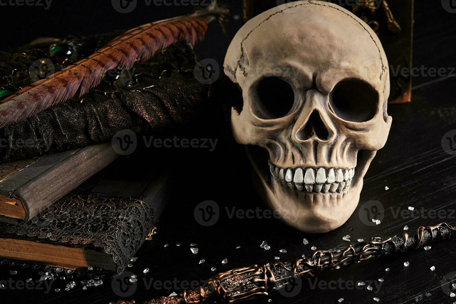 Realistic model of a human skull with teeth on a wooden dark table, black background. Medical science or Halloween horror concept. Close-up shot. photo