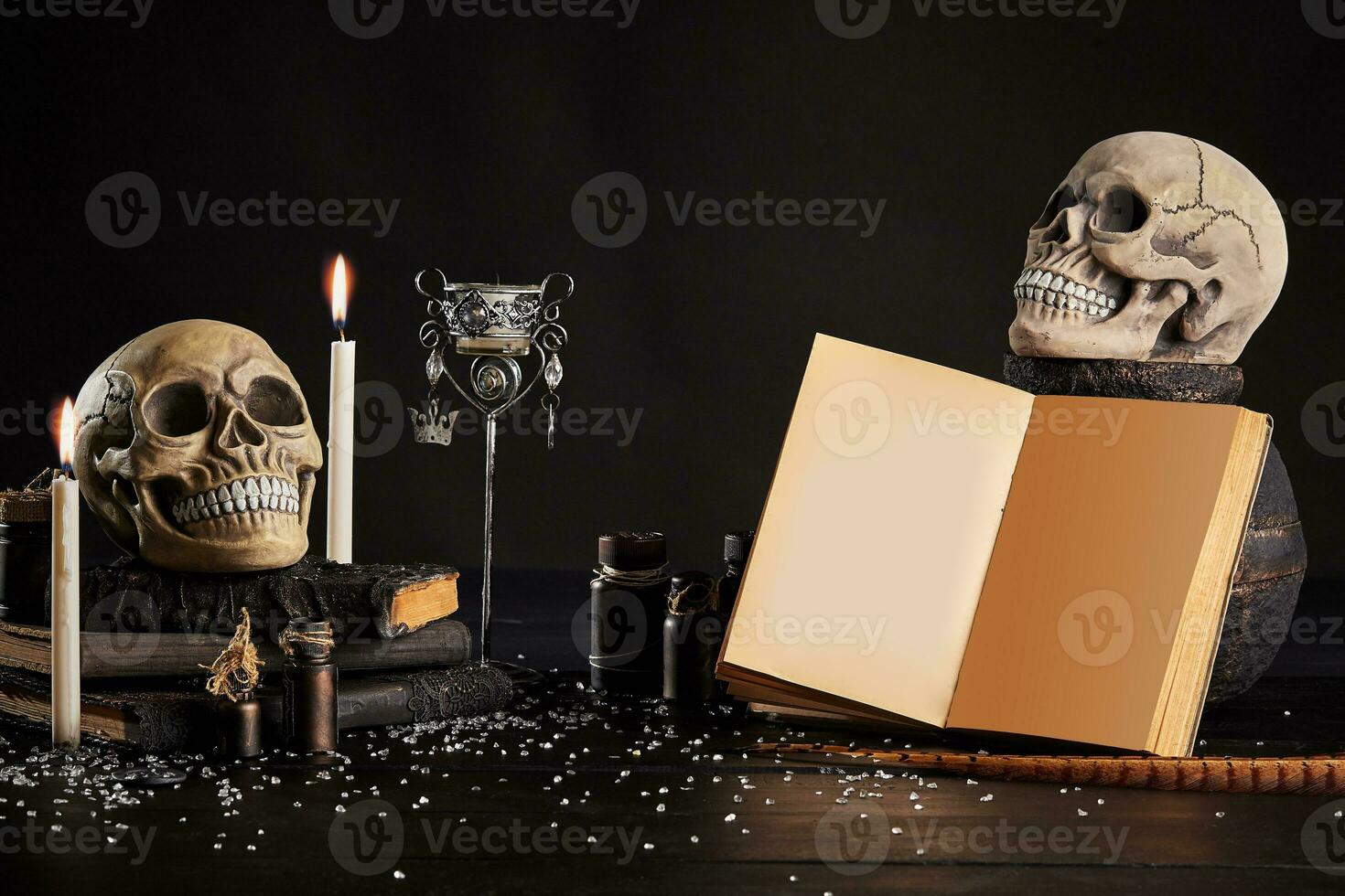 Realistic model of a human skull with teeth on a wooden dark table, black background. Medical science or Halloween horror concept. Close-up shot. photo