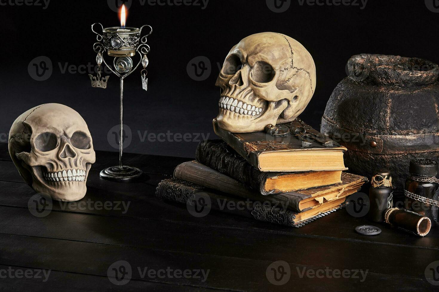 Realistic model of a human skull with teeth on a wooden dark table, black background. Medical science or Halloween horror concept. Close-up shot. photo