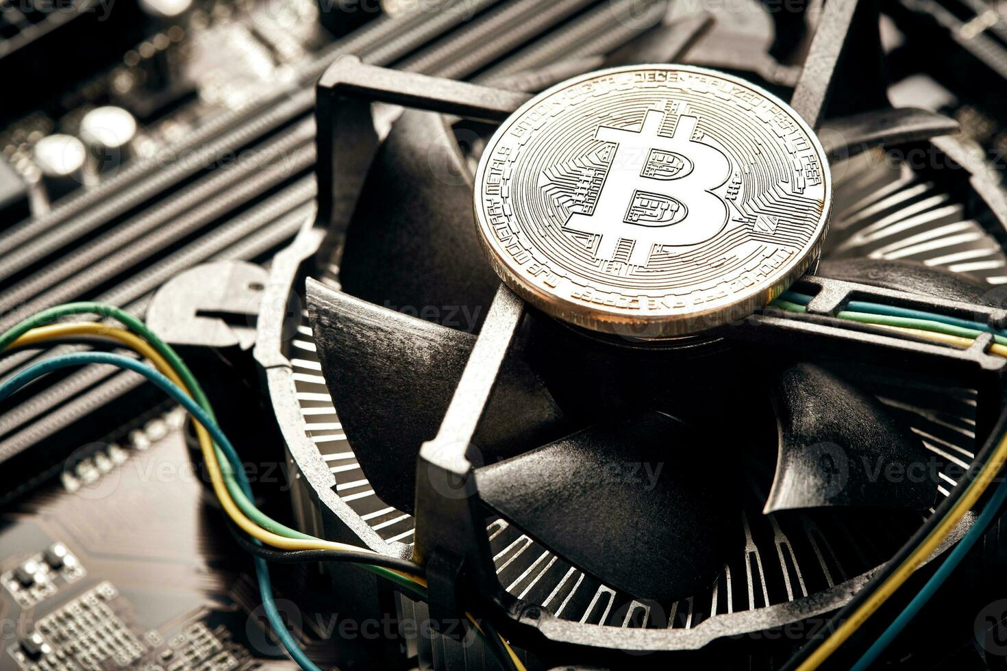 Bitcoin. New virtual money. Bitcoins lie on the video card, concept of mining. photo