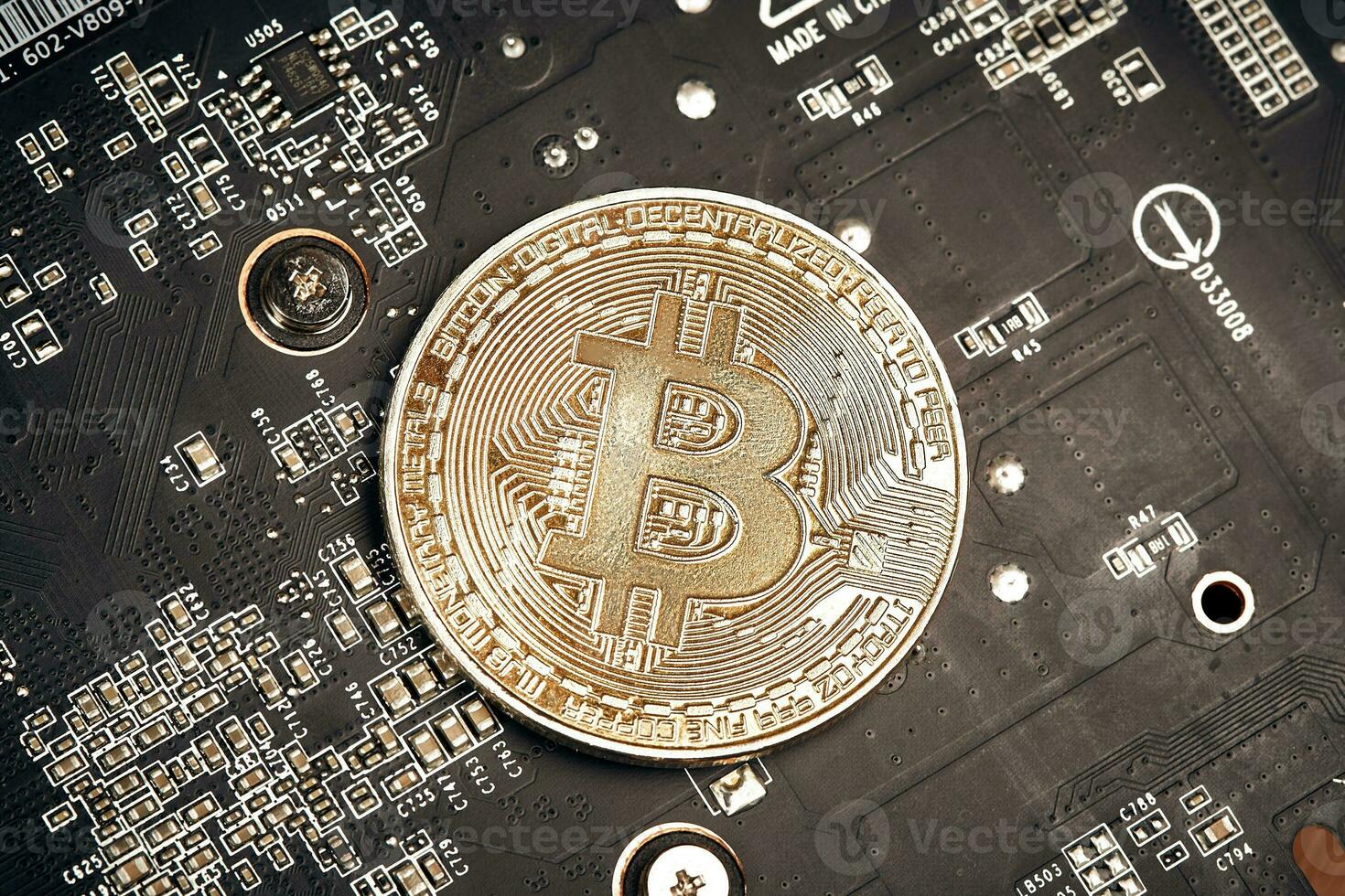 Bitcoin. New virtual money. Bitcoins lie on the video card, concept of mining. photo