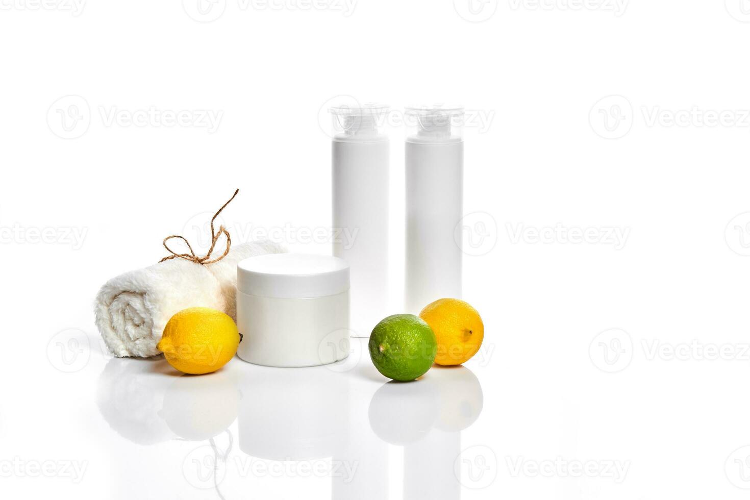 White bottles and two whole lemon and lime isolated on white background. The concept for advertising cosmetics photo