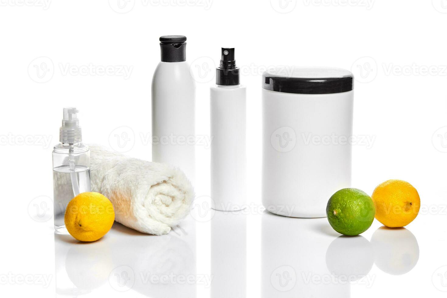 White bottles and two whole lemon and lime isolated on white background. The concept for advertising cosmetics photo