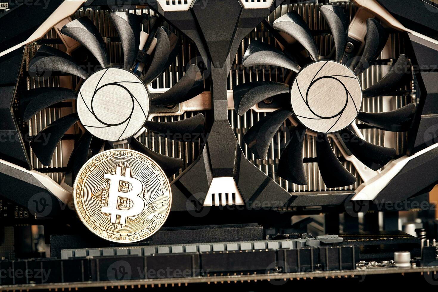 Bitcoin. New virtual money. Bitcoins lie on the video card, concept of mining. photo