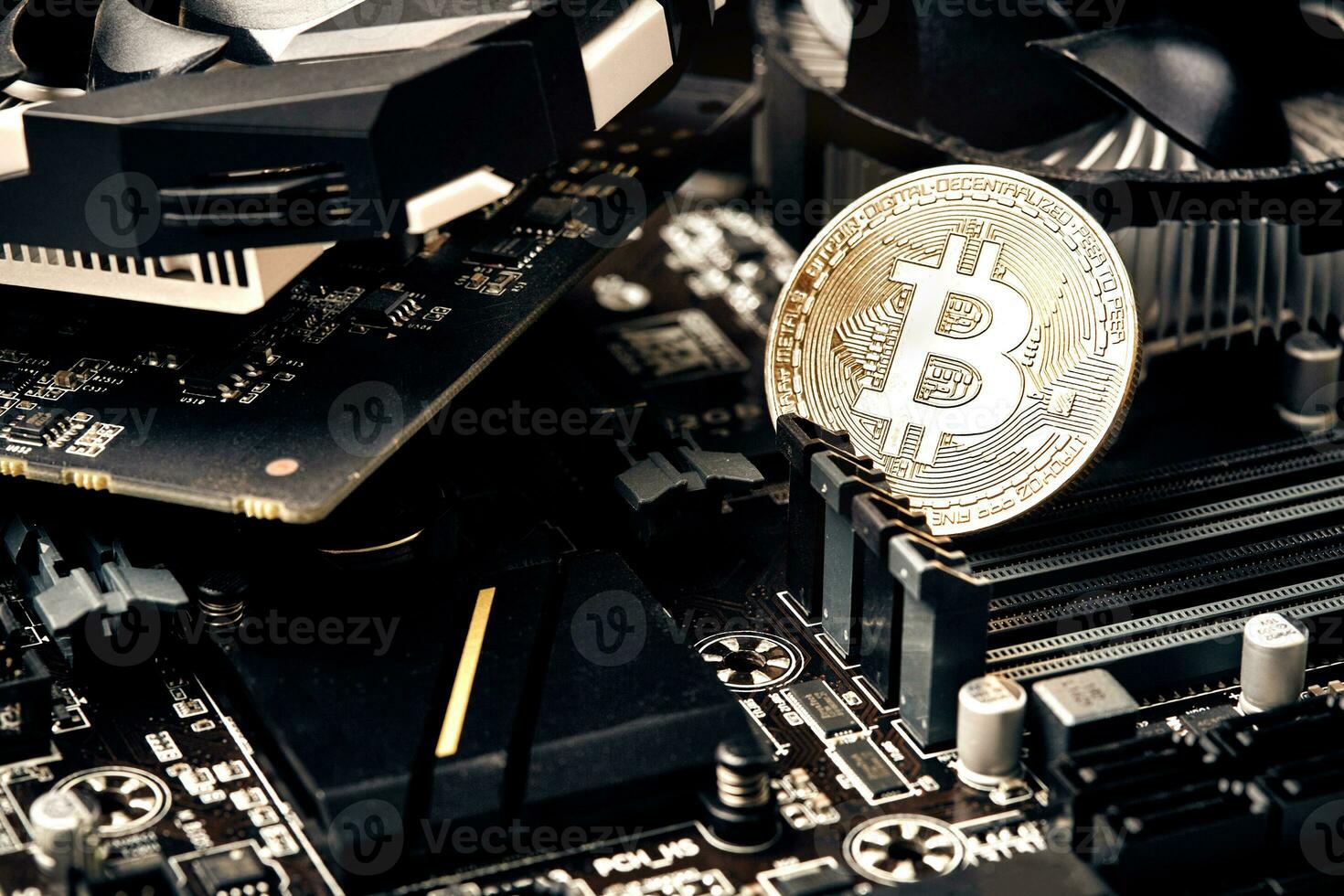 Bitcoin. New virtual money. Bitcoins lie on the video card, concept of mining. photo