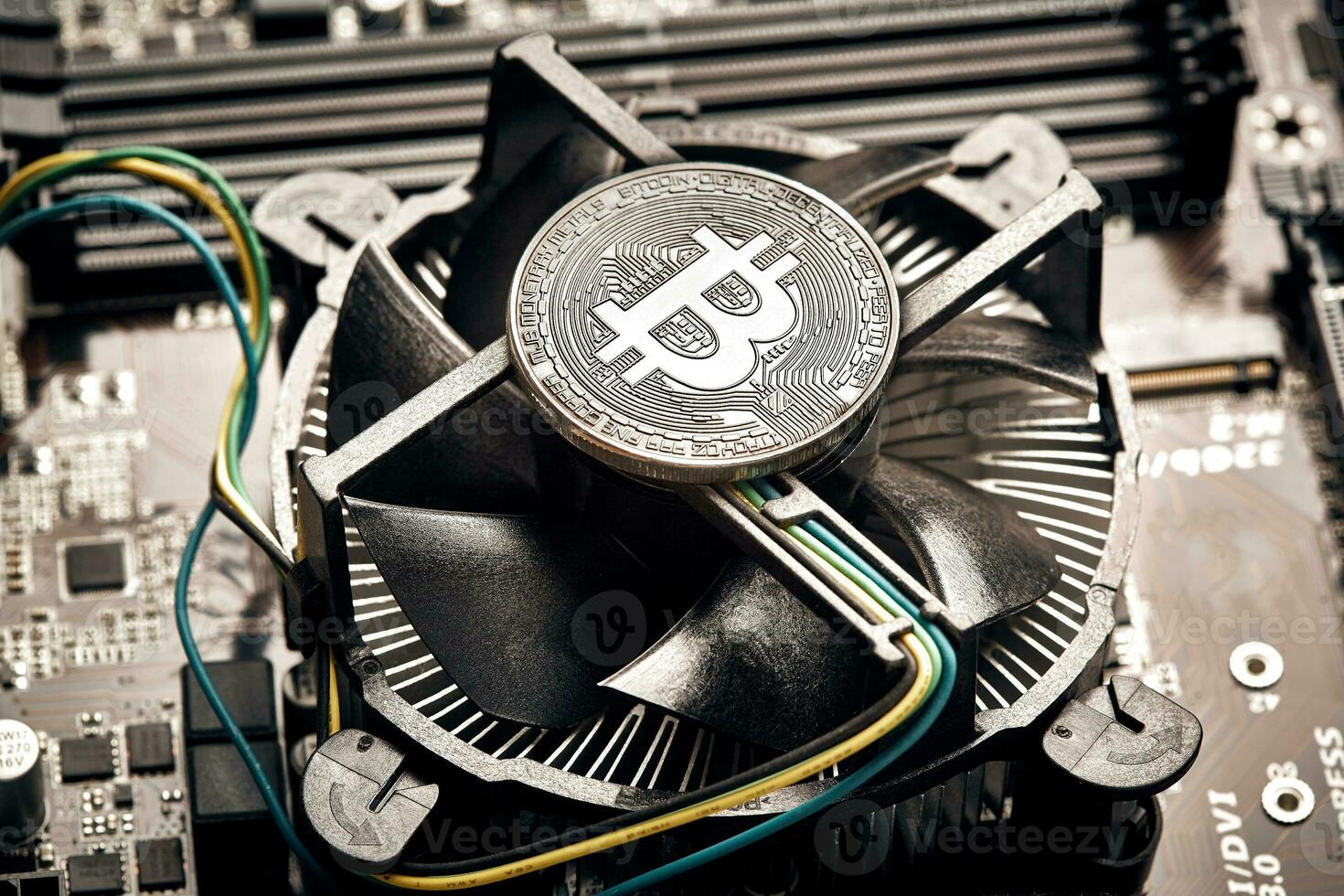 Bitcoin. New virtual money. Bitcoins lie on the video card, concept of mining. photo