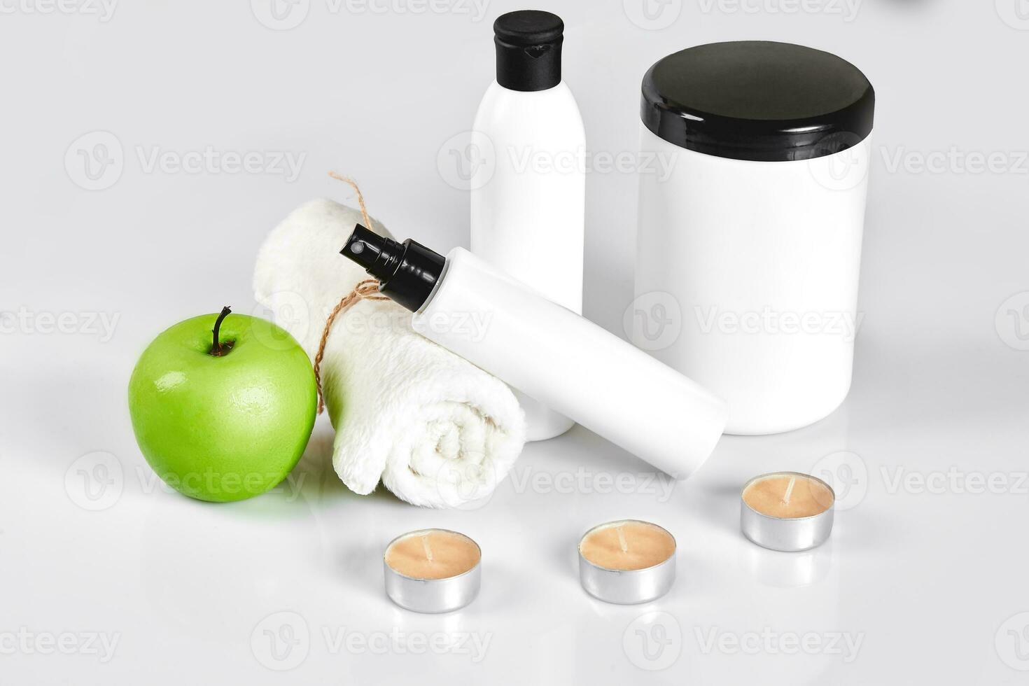 Natural spa beauty treatment cleansing products with apple on white background. photo