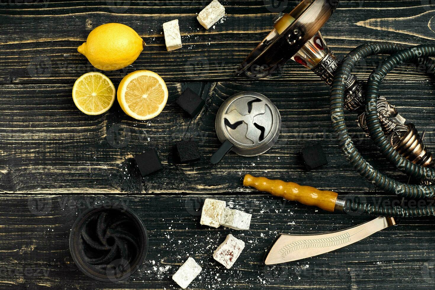 Dismantled parts of hookah on a wooden background with lemon fru photo