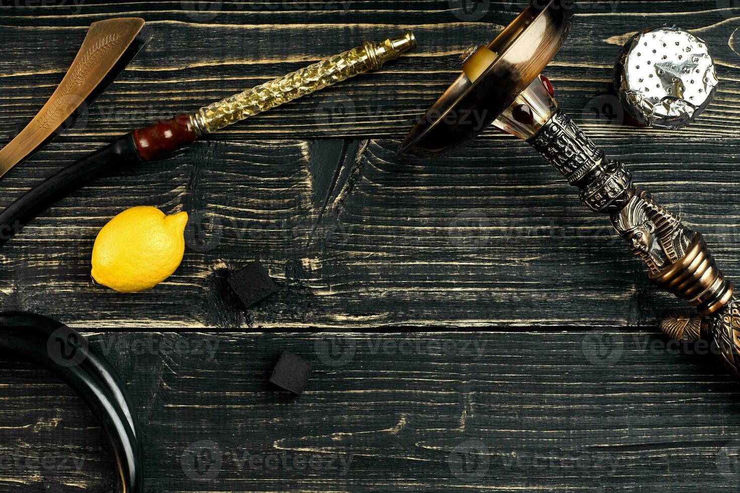 Dismantled parts of hookah on a wooden background with lemon fru photo
