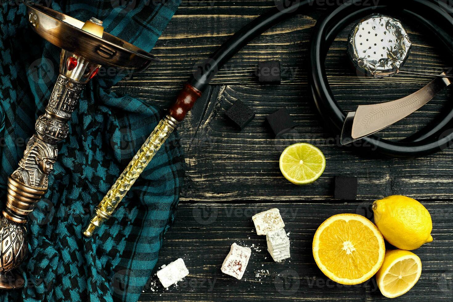 Top view of Hookah with orange fruit on a wooden background photo