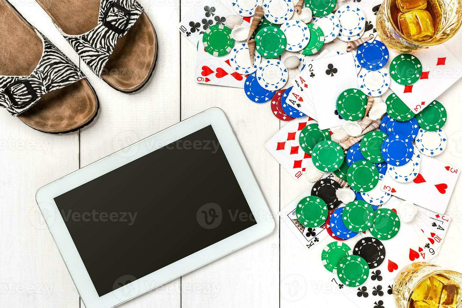 Gambling. Poker chips, cards and the dice nearby tablet on wooden table. Top view. Copyspace. Poker photo