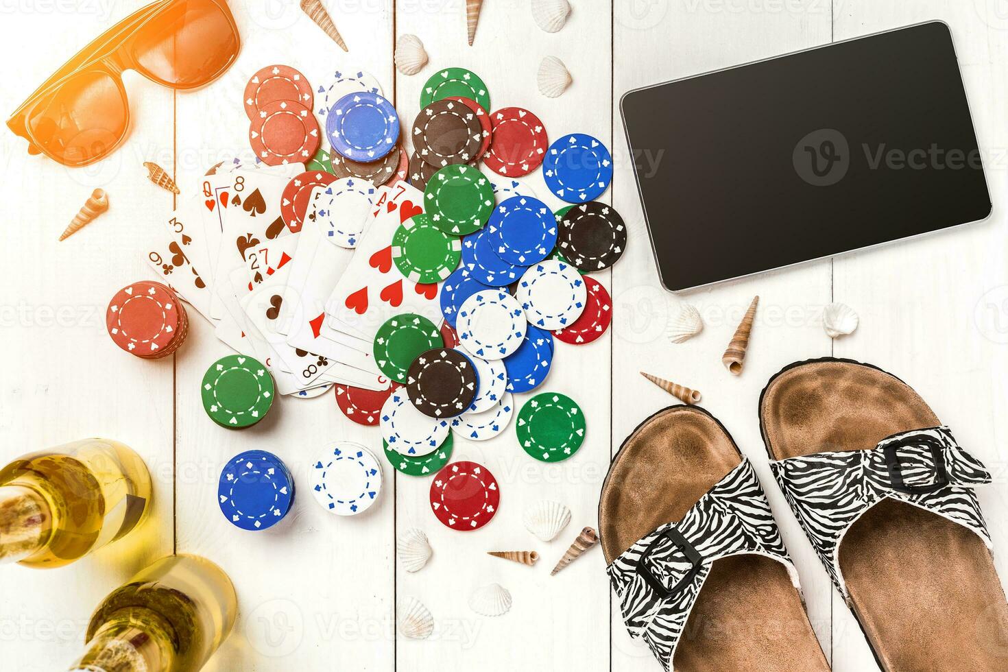 Gambling. Poker chips, cards and the dice nearby tablet on wooden table. Top view. Copyspace. Poker photo