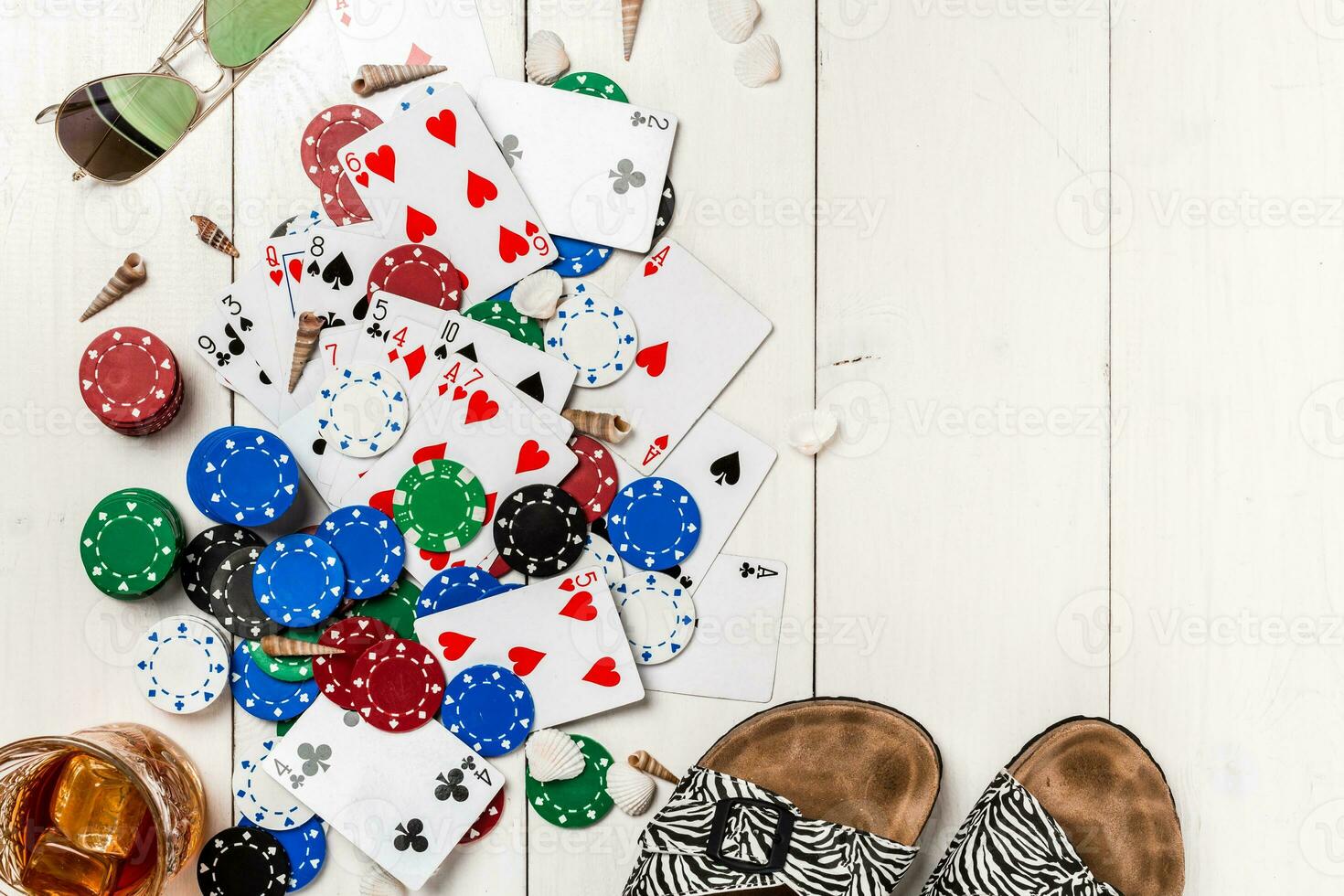 Gambling. Poker chips, cards and the dice nearby tablet on wooden table. Top view. Copyspace. Poker photo