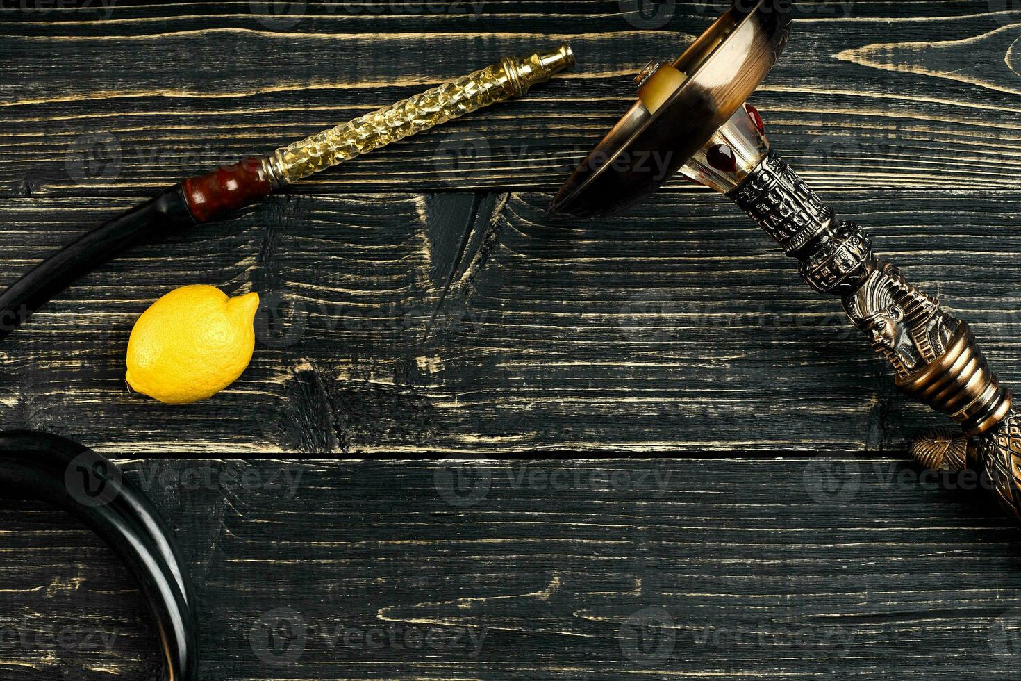 Dismantled parts of hookah on a wooden background with lemon fru photo