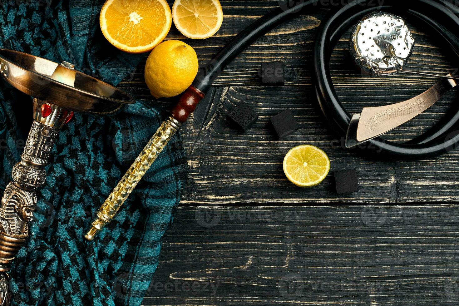 Top view of Hookah with orange fruit on a wooden background photo