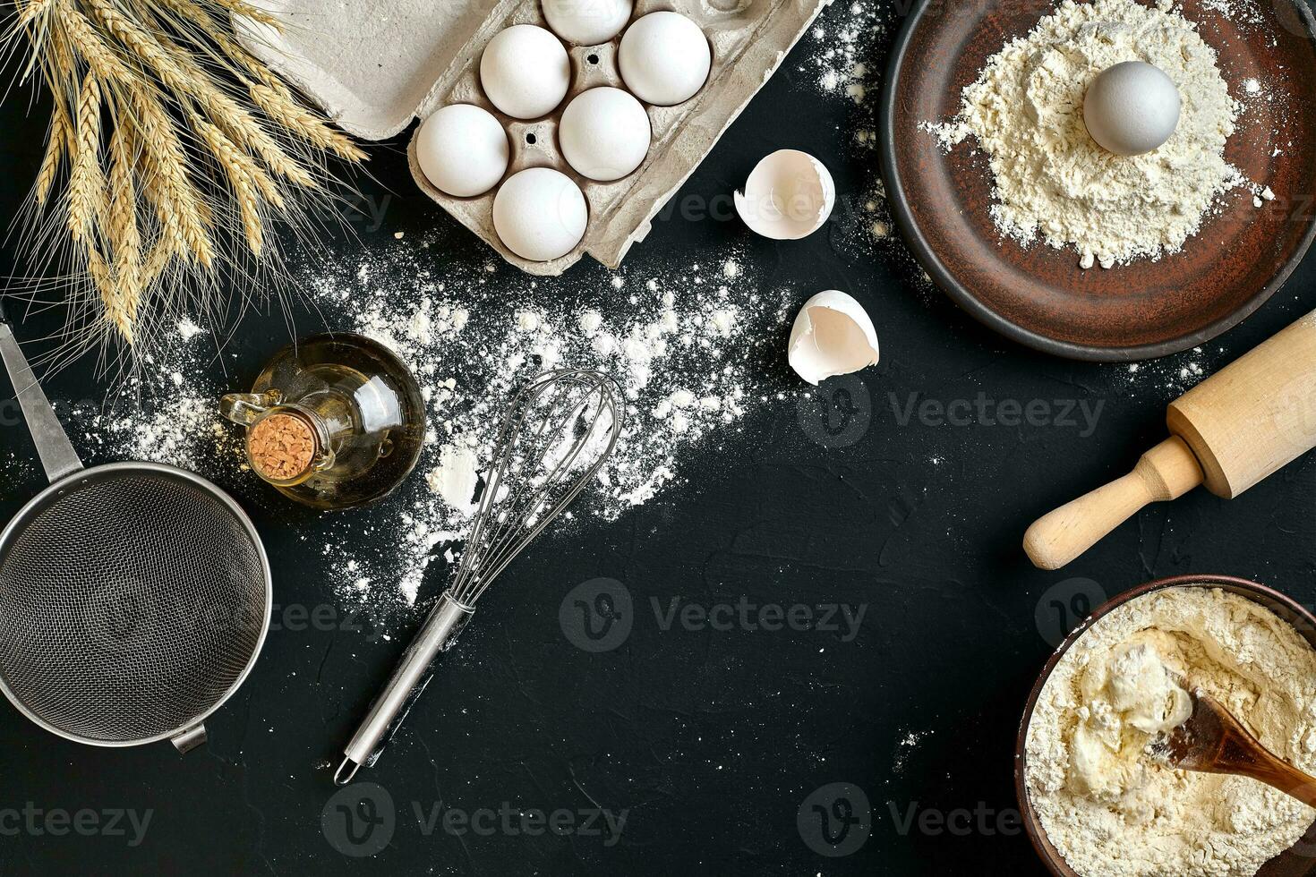 Pasta cooking ingredients on black kitchen table. Top view with space for your text photo